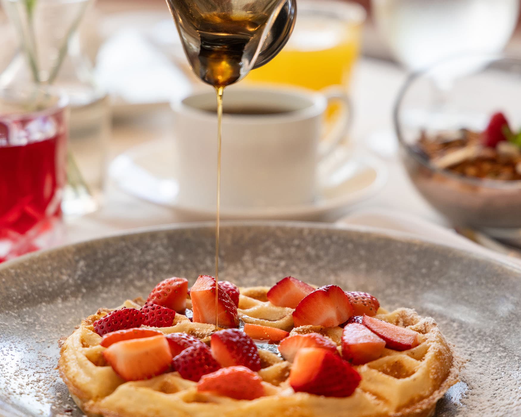 Waffles, strawberries, and maple syrup at Marquesa