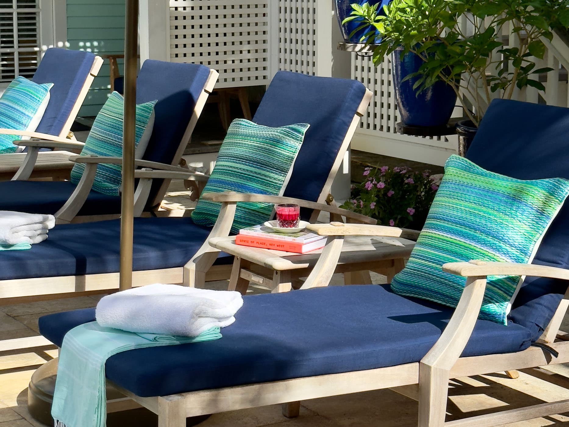 Up close of 4 lounge chairs poolside at Marquesa