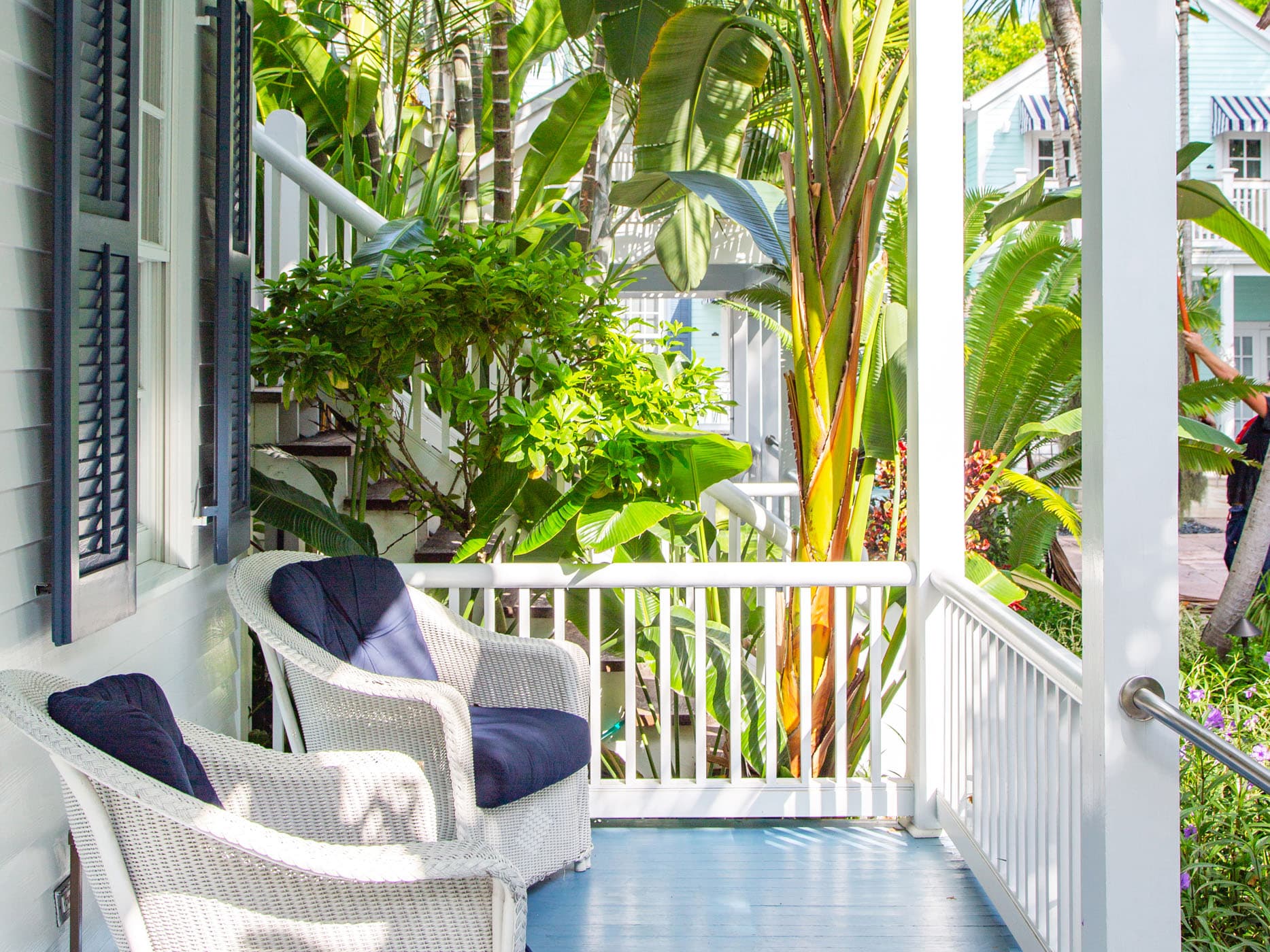A porch with 2 wicker chairs off of a room at Marquesa